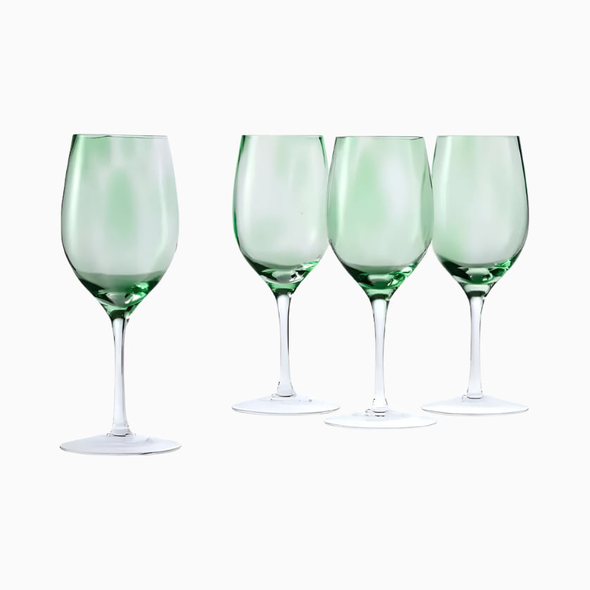 A set of four 10 oz Blue Rose Polish Pottery Green Confetti wine glasses is displayed in a row on a white background, highlighting the elegant craftsmanship of Polish glassware.