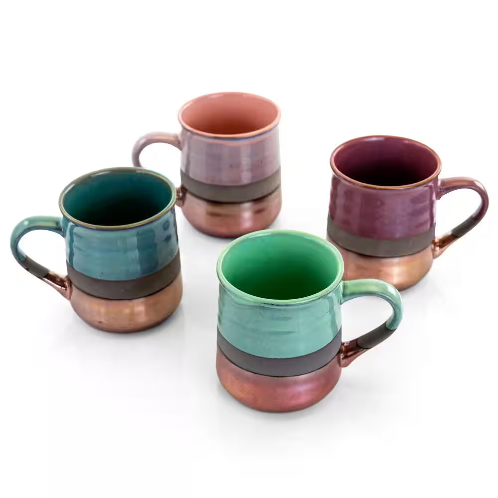 The 18 oz. Assorted Stoneware Mug Set (4-pack) features green, teal, purple, and mauve mugs with metallic copper bottoms, arranged on a white surface.