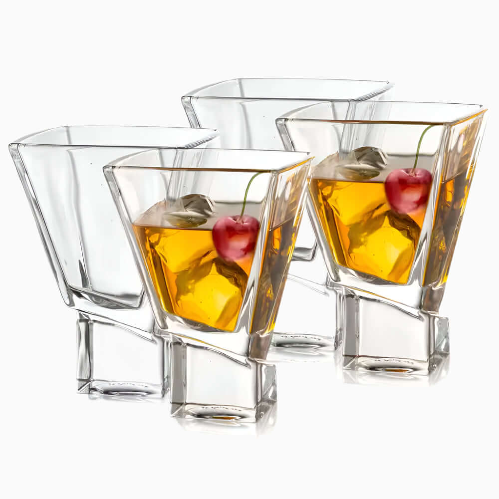 Four Carre Square 8 oz. Martini Glasses, handmade with care—three filled with amber liquid, ice, and a cherry, one empty—all showcased on a white background.