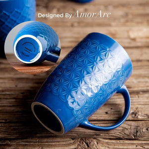A Large Coffee Mugs Set of 6 (22oz) in blue ceramic features a geometric embossed pattern, with an inset of the base showing Designed By AmorArc branding. These tall mugs are lead and cadmium free for safe daily use.