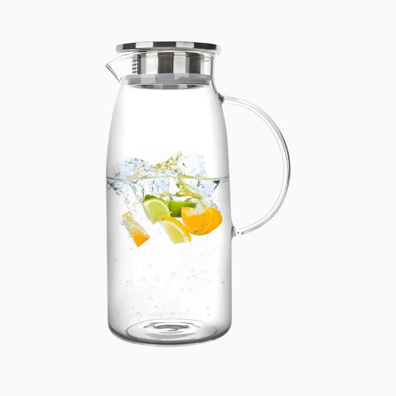 The Macchiaco 60 Ounces Glass Pitcher with Lid, made of clear borosilicate glass, is shown filled with water and slices of lemon, lime, and orange floating inside against a plain white background.