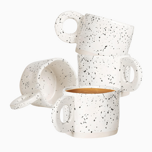 The Ceramic Coffee Mugs, Stoneware Coffee Cups Set of 4 (10oz) features white mugs with black speckles, stacked on a white background. These cups are dishwasher and microwave safe for convenient everyday use.