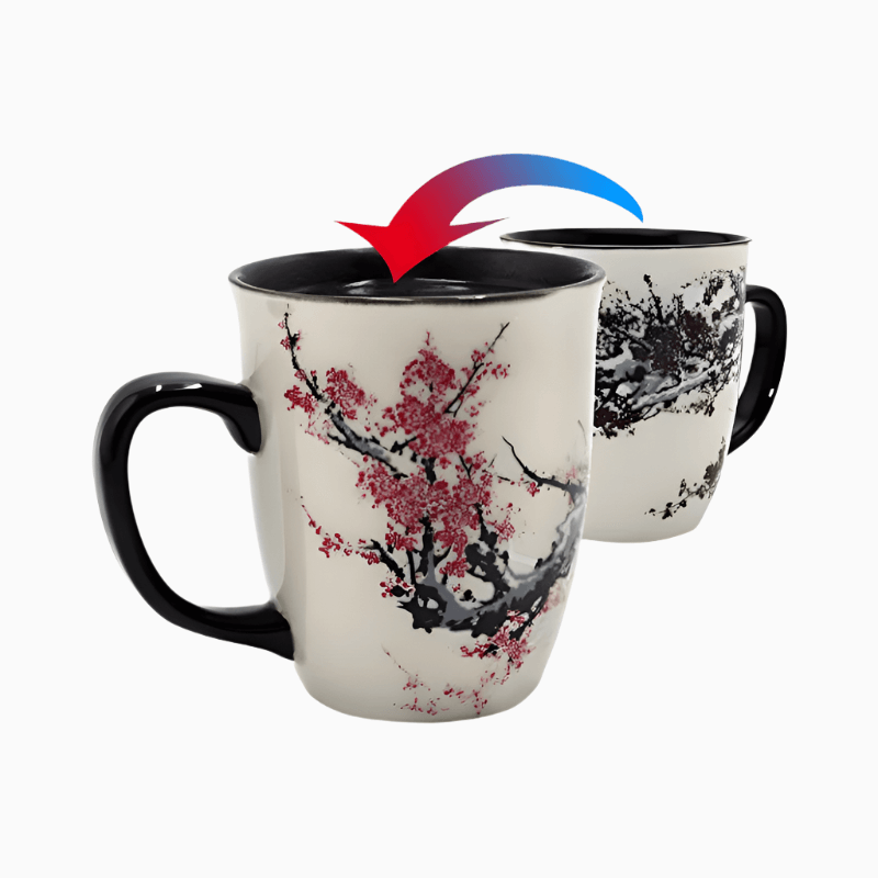 The Color Changing Heat Sensitive Magic Porcelain Mugs 16oz features a cherry blossom design that shifts from black-and-white to vibrant red when you add a hot drink.