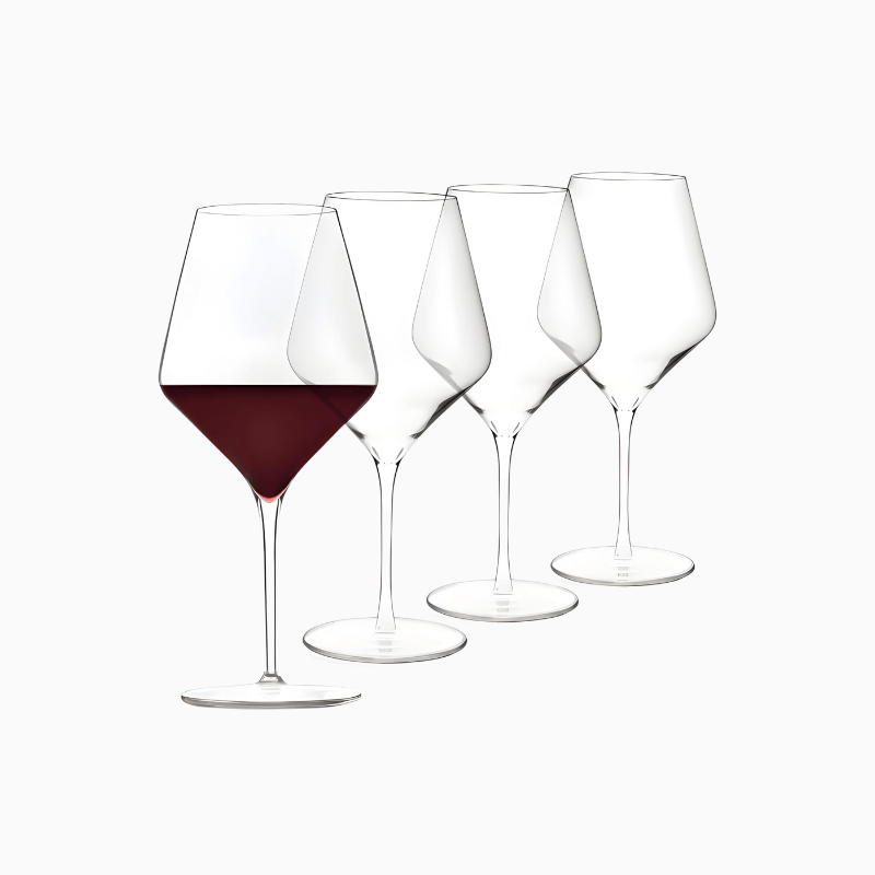 Four Signature Greenwich wine glasses are lined up, with the first one filled with red wine and the others empty, showcasing the elegance of the 12 Piece Party Wine Glasses Set.