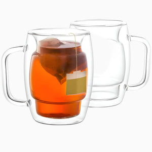 Set of 2 clear, 10-oz Glass Coffee Cups with double-wall insulation and handles; one filled with tea and a tea bag, one empty—both shown on a white background. These stylish mugs are microwave safe for your convenience.