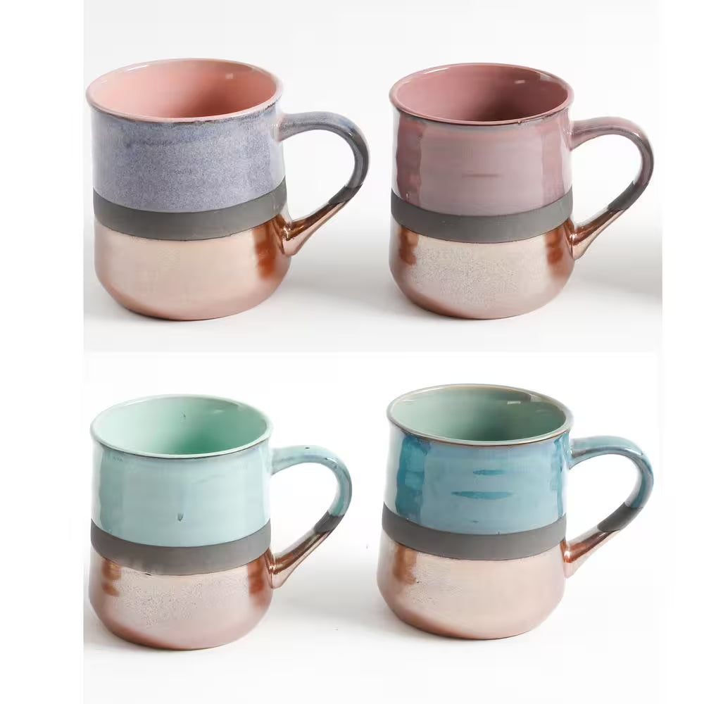 The 18 oz. Assorted Stoneware Mug Set (4-pack) features metallic copper bottoms and pastel tops in pink, purple, mint green, and blue. Stylishly arranged against a white background, these dishwasher-safe mugs combine function and flair.