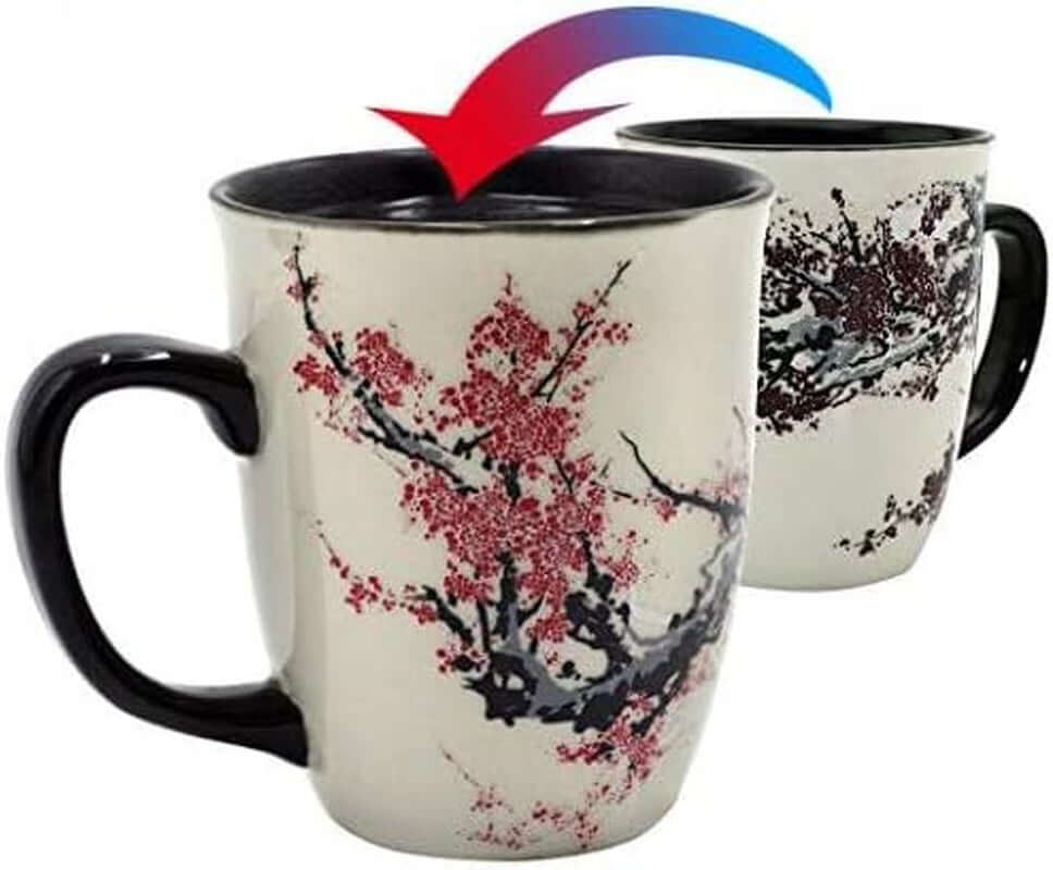 Set of two 16oz Color Changing Heat Sensitive Magic Porcelain Mugs, each with a cherry blossom design that transforms when filled with hot liquid—an arrow highlights the color changing effect.