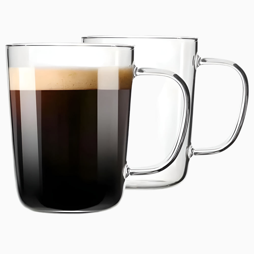 The Glass Coffee Mugs (Set of 2, 17 oz) are displayed—one filled with foamy black coffee and one empty—showcasing their lead-free glass, comfortable handle, modern design, and durability against a plain white background.
