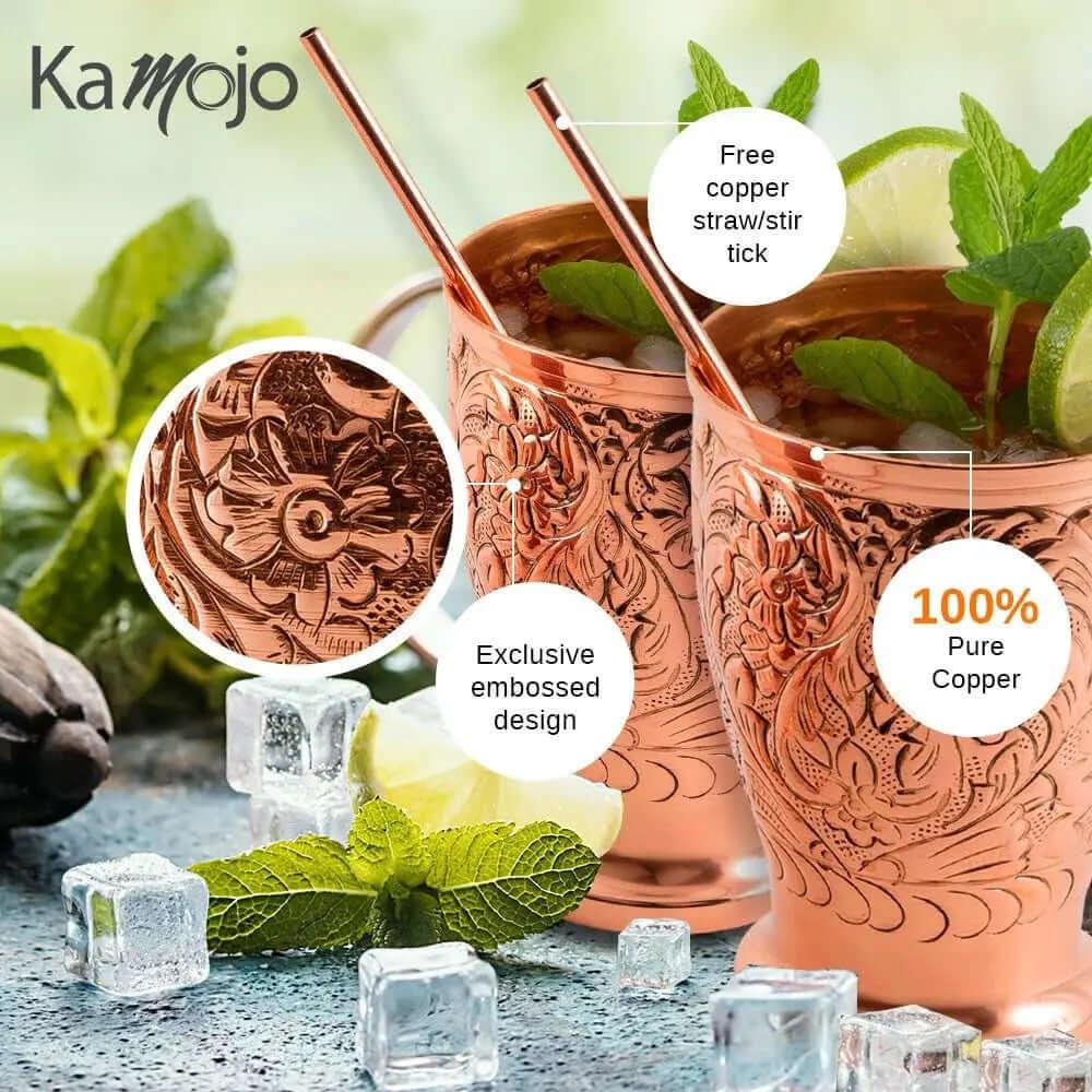 The Moscow Mule Pure Copper Mugs - Embossed Set is shown with ice, mint leaves, and straws, highlighting its pure copper material, exclusive embossed design, and includes 4 matching shot glasses.