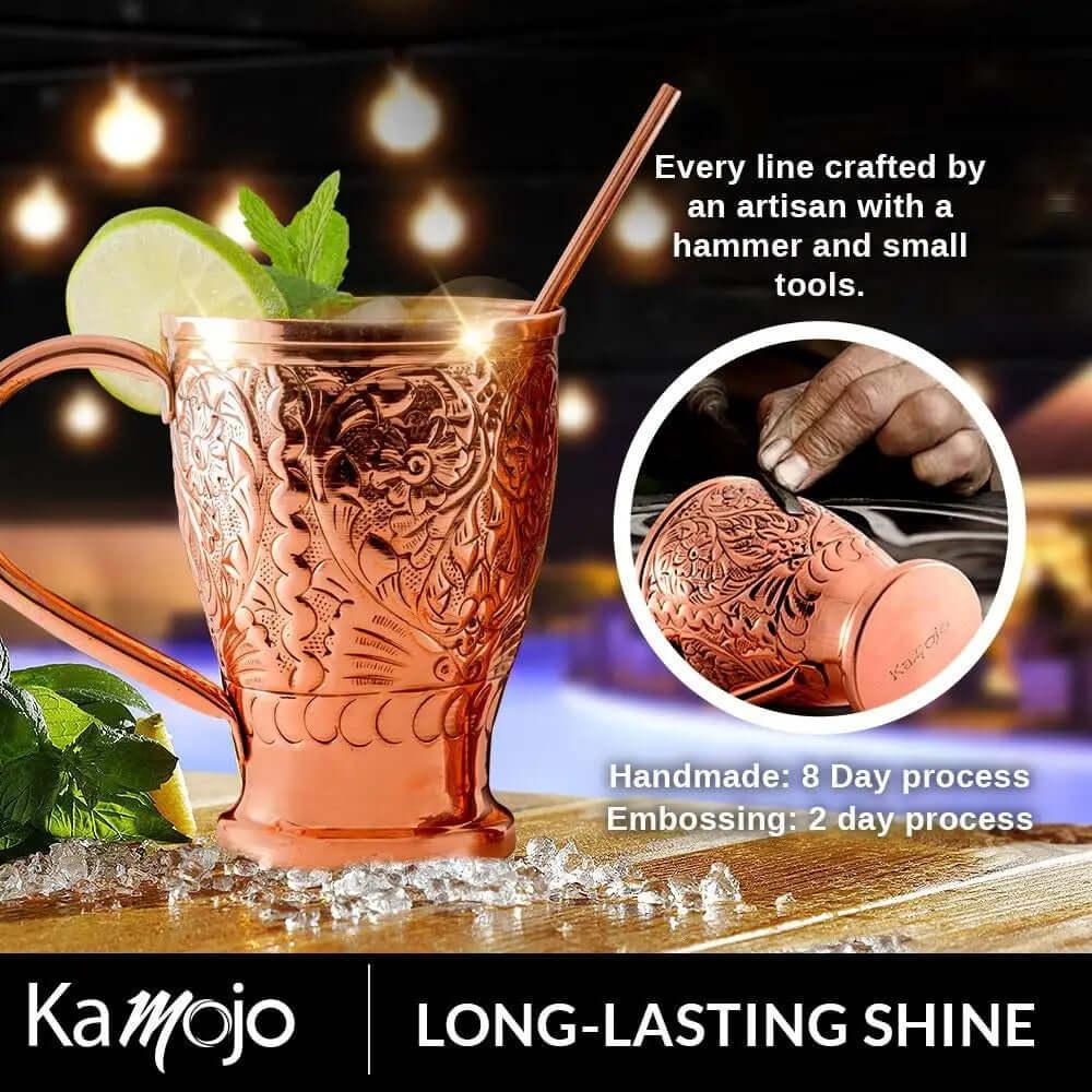 The Moscow Mule Pure Copper Mugs - Embossed Set includes handcrafted mugs with detailed embossing, four matching shot glasses, and a copper straw, showcasing artisan quality and lasting shine.