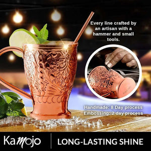 The Moscow Mule Pure Copper Mugs - Embossed Set includes handcrafted mugs with detailed embossing, four matching shot glasses, and a copper straw, showcasing artisan quality and lasting shine.