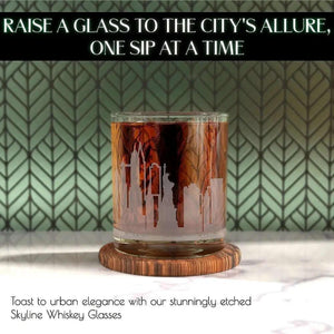 A 10 oz Whiskey Glass Tumbler for New York Lovers, sand-etched with a city skyline, is filled with dark liquor and placed on a wooden coaster against a patterned backdrop.