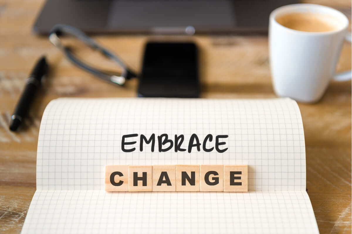 Image of words that read "Embrace change" on a office table