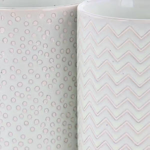 The Madrina 4 Piece 19 oz. Stoneware Mug Set in Mint features assorted designs, including polka dots and chevron, with two stylish white mugs placed side by side.