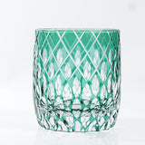 The Macchiaco Fashion Hand Carved Crystal Glass Cup features a short, round design with a green tint and diamond-cut pattern, blending modern simplicity. Displayed against a plain white background.