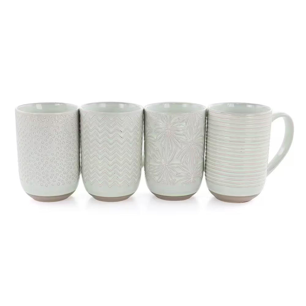 The Madrina 4 Piece 19 oz. Stoneware Assorted Designs Beverage Mug Set in Mint includes four microwave safe mugs, each with a unique textured pattern: dots, zigzags, leaves, and horizontal lines.