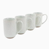 The Madrina 4 Piece 19 oz. Stoneware Assorted Designs Beverage Mug Set in Mint features four microwave-safe mugs with handles, assorted embossed patterns including florals, and slightly exposed brown bases, all arranged in a row.