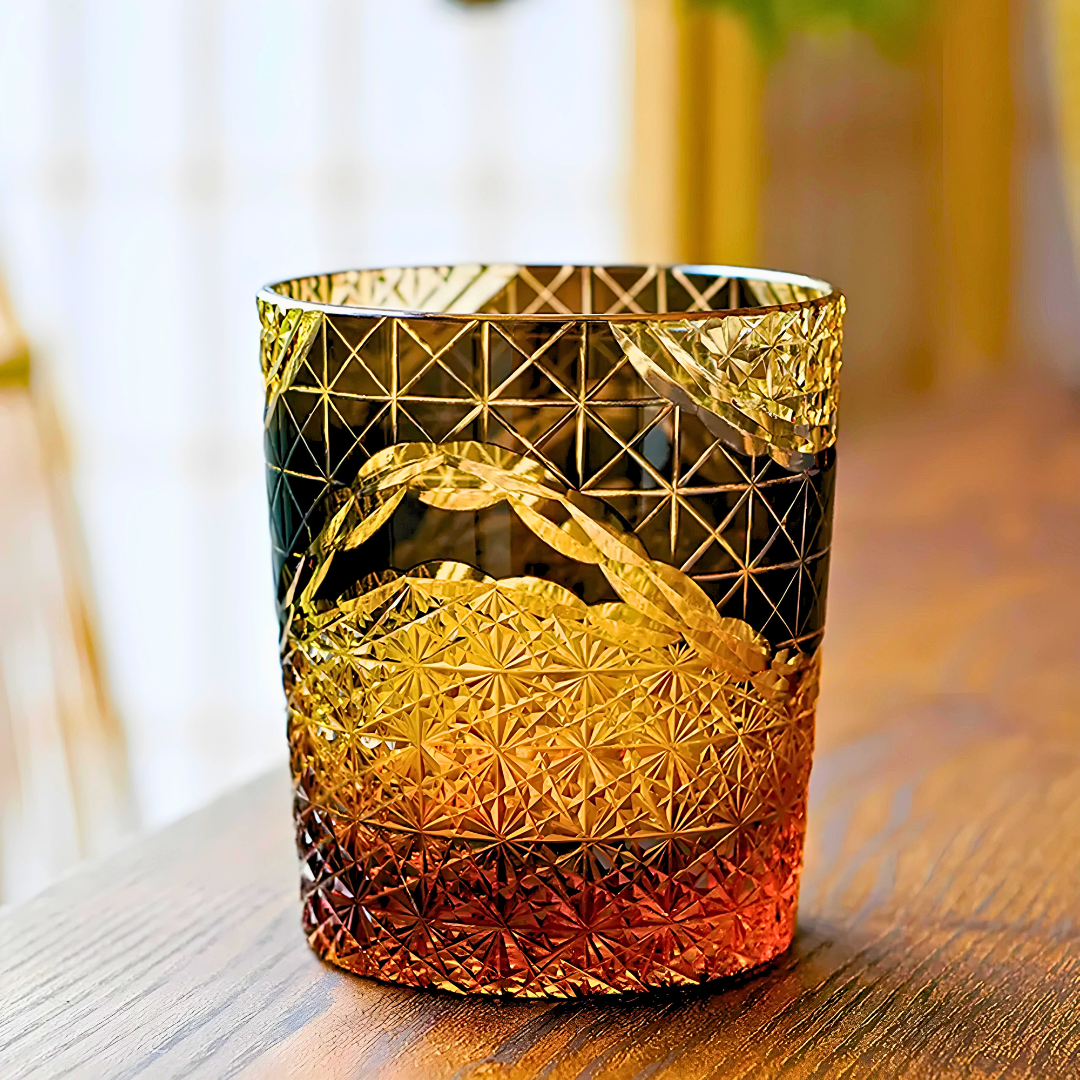 The Crystal Whiskey Glasses (8 Oz)—ideal for bourbon or scotch—feature a handcrafted faceted design with an amber-to-gold gradient, beautifully reflecting Japanese craftsmanship on a sunlit wooden surface.