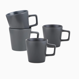 The Stoneware Coupe 4-piece mug set features grey matte 12oz mugs with square handles, arranged on a white surface—two stacked and two standing alone. These dishwasher-safe mugs offer the perfect blend of style and convenience.