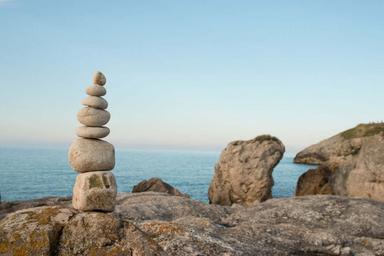 Image of rocks stacked on the top of a larger rock